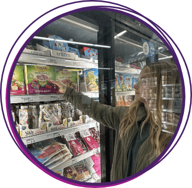 Woman grabbing Fruit Pearls from the Freezer section of the grocery store
